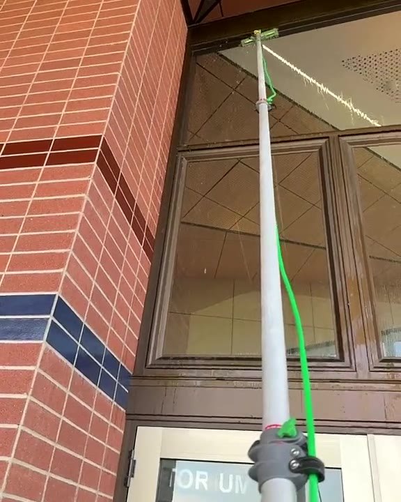 Water-fed pole window cleaning on a commercial building, Toowoomba